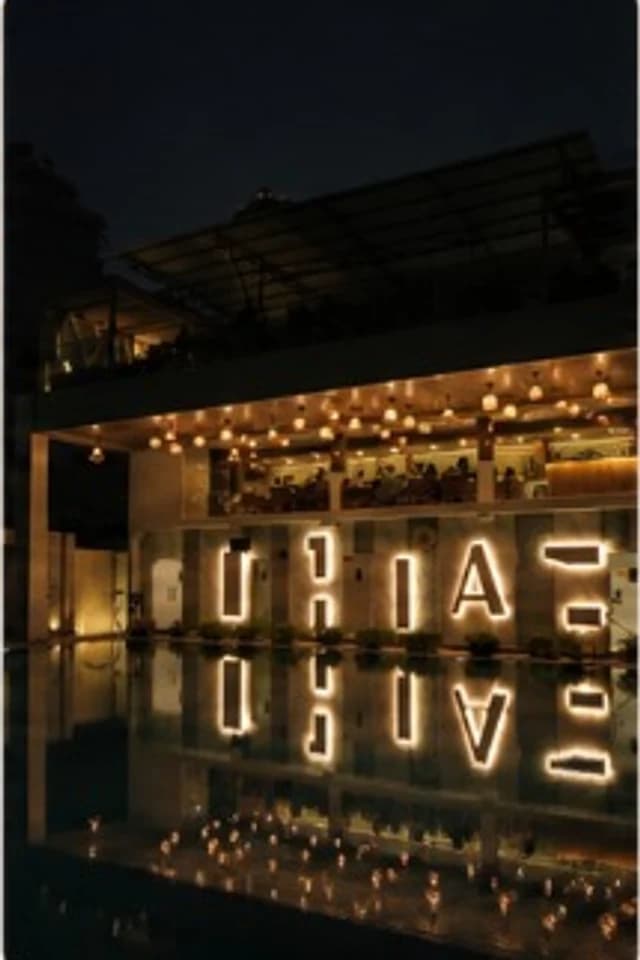 Ananta at night reflected in the pool
